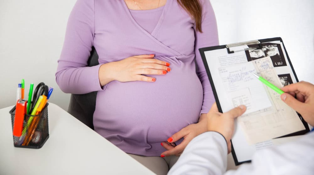 A pregnant woman consulting with a doctor about test results