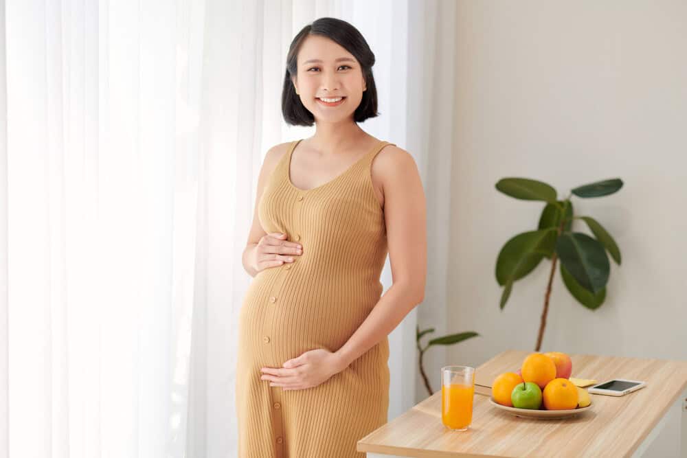 A young pregnant woman holding her stomach