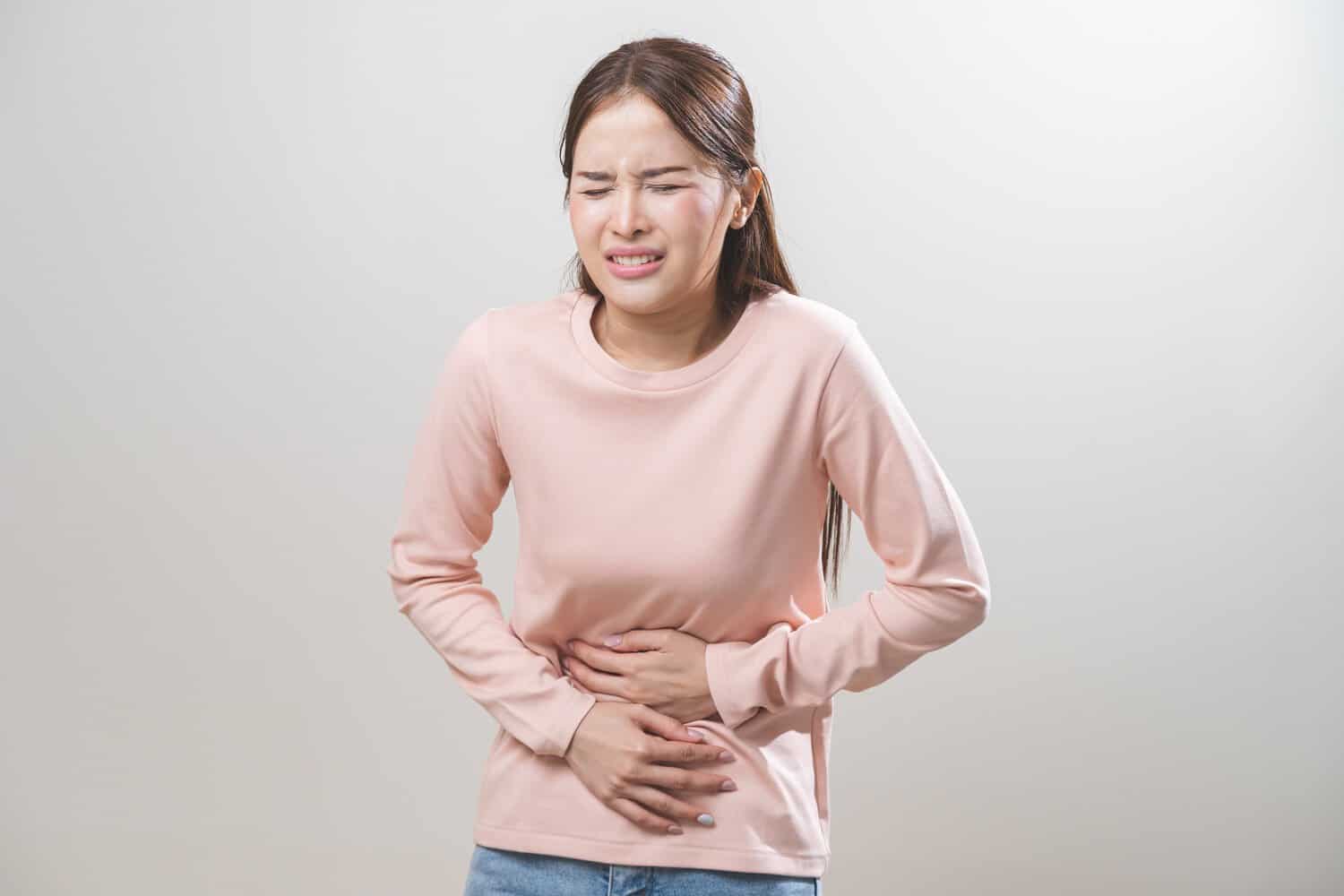 A woman suffers pain associated with menorrhagia.
