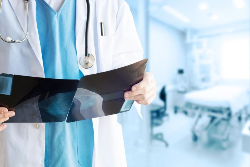 Doctor reviewing mammogram showing benign breast calcification suitable for ICSI